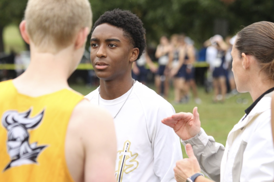 Coach Kim Martin and Sophomore Devin Alexander talk before the teams October 14th run at McNair Park. Devon would go on to finish with a time of 17:28