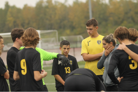 The JV soccer team huddles together during half-time of their game on Oct. 14.