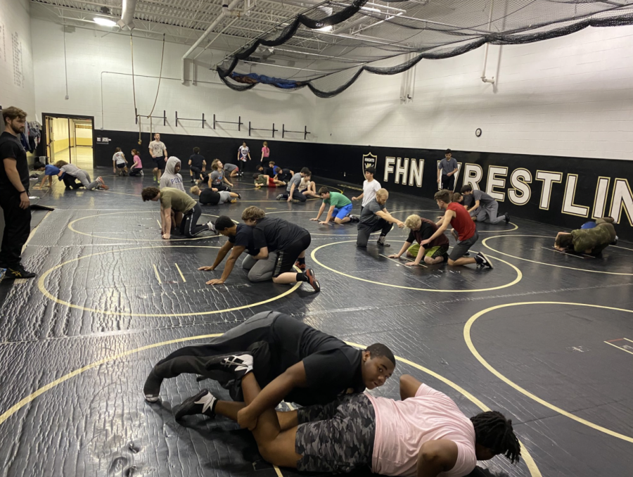 The Wresting team practices together in the wresting room at the beginning of their season 
