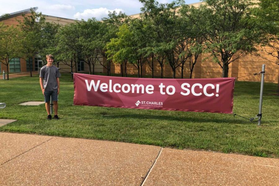 Junior Nolan Walters poses in front of welcome sign for St. Charles Community College.