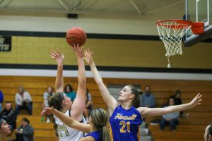 An FHN player shoots the ball towards the net on Dec. 8 against Howell high