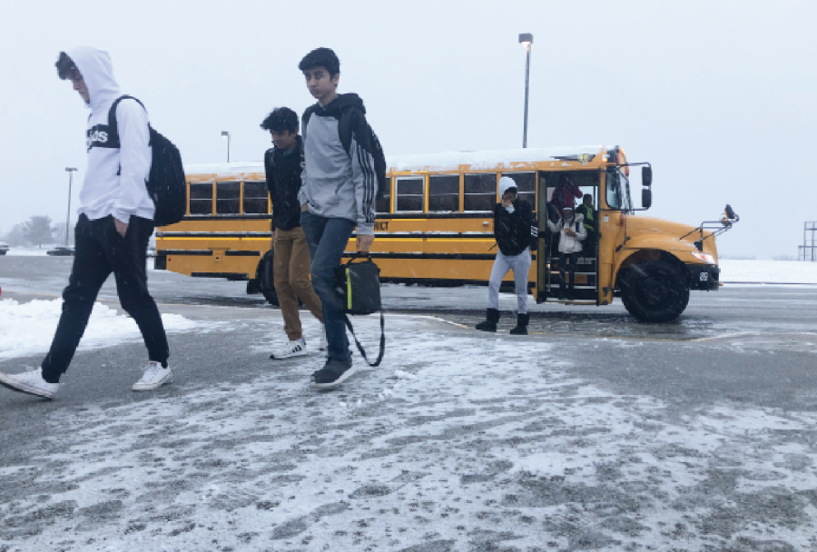 FHN students walk in from the bus lot on a snowy day. 
