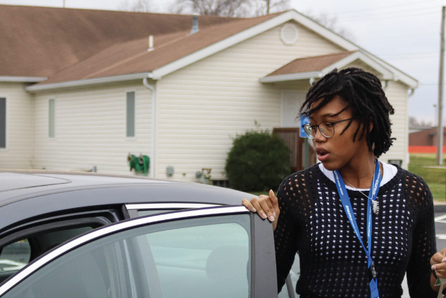 Senior Nila Milo gets out of her car to walk from the church to school. Due to the limited parking in FHN’s parking lot with ongoing construction, students were given permission to park there.