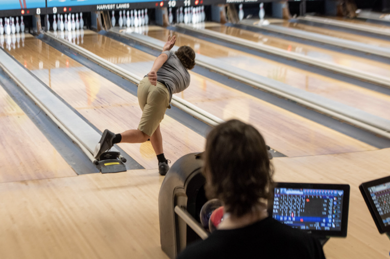 An FHN bowling team member watches their fellow teammate bowl their round. 
