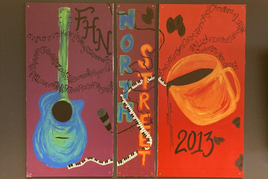 Live coffeehouse artwork painted by Lindsey Usry and Alex Brinovec during Coffeehouse is displayed in the Learning Commons