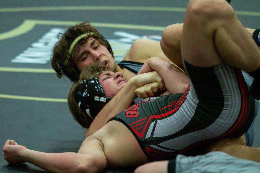 Junior Chad Blank wrestles his opponent to the ground. 