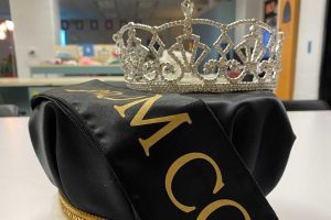 The prom crowns and sash are displayed in a classroom.