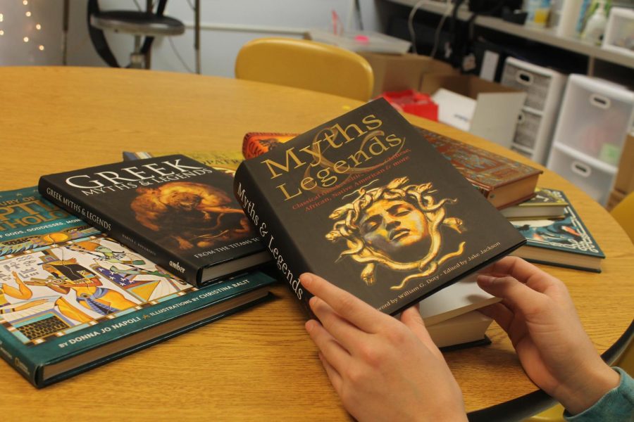 On Dec. 1 in room 131, sophomore Addison Polsgrove sits with multiple mythology books. 