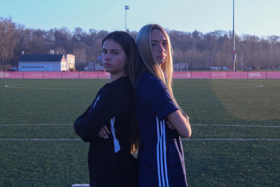 Juniors Sami WIlson and AnnaRose Eldred stand together on a soccer field at Lou Fusz Soccer Comples. (Photo by Etaf Abdallah)