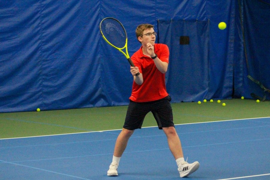 Freshman+Luke+Dickherber+hits+the+tennis+ball+across+the+net+at+practice.+FHN+Tennis+currently+practices+at+Vetta+West+due+to+construction+of+the+new+FHN+Building.+