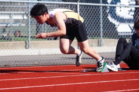   Sophomore Brandon Lin takes off from
a block start on April 1 in a track meet at Francis Howell Central. (Photo by Amoolya Pandurangi)