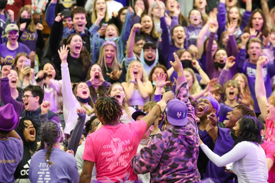 Emcees Trenton Oglesby, Logan Currie, Cat Connolly, and Chas Hoskins hold the microphone towards the senior class during a pep assembly. The crowd was playing a game called finish the lyric. This Snowcoming pep assembly was the senior class of 2022s last pep assembly before graduation. The seniors all wore purple, their class color, for the assembly. 