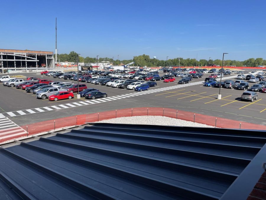The parking lot is shown with many cars parked in it.