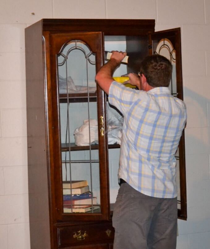 A participant searches through a cabinet during the Infection Escape Room that was held in the auditorium of Oct. 14. 