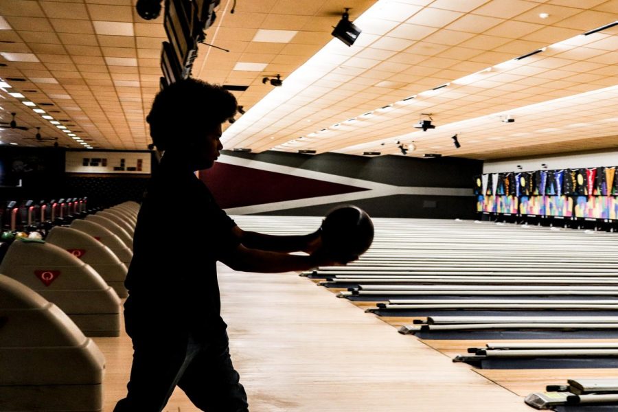 Senior Julius Cox prepares to throw his bowling ball down the lane on November 27th. Bowling is a sport where the individual tosses a ball down a lane to aim at targets, which are bowling pins. Bowling is both a competitive and recreational activity that many can participate in.