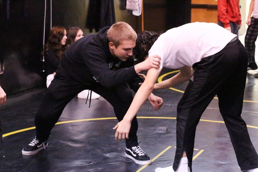 Conley works directly with the wrestlers to help get the feel and the correct movements while on the mats before their first match of the winter season. 