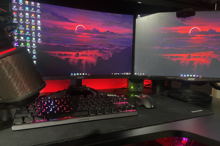 Nico Schuchman, a senior on the esports team, has a gaming setup at his house. The image shows Schuchman’s Steel Series Apex Pro TKL Keyboard, a Logitech G502 mouse, along with dual monitors, headphones, a microphone and speakers. 