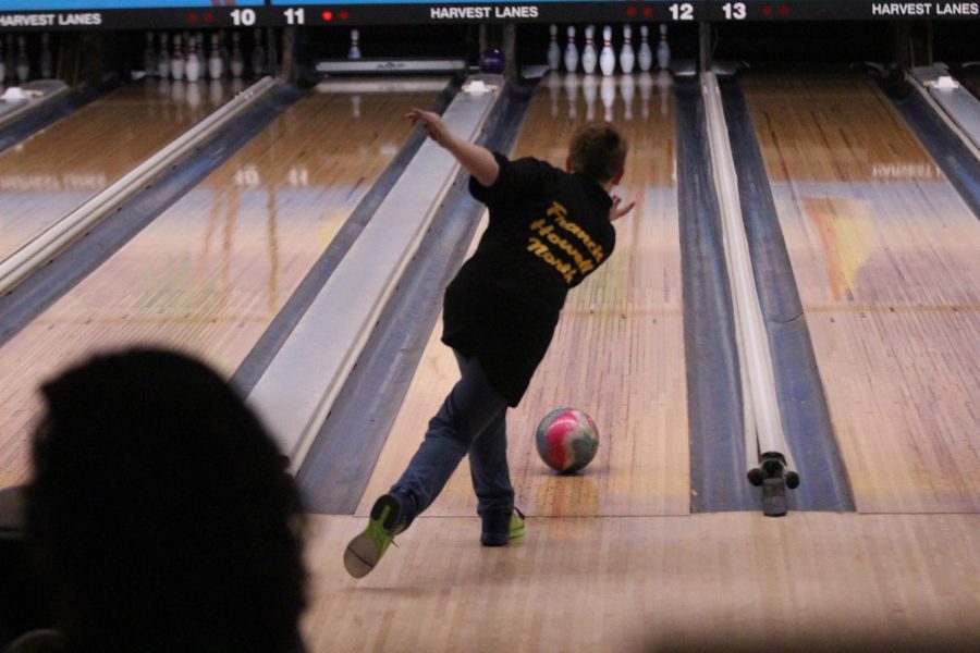 FHN+bowler+throws+the+ball+down+the+lane+during+a+match+hoping+to+hit+as+many+pins+as+they+can.