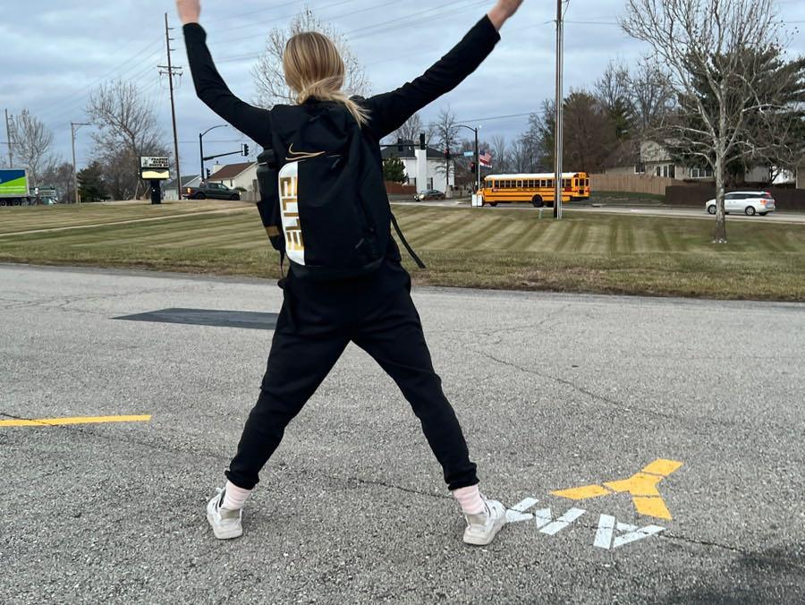 FHN JV/Varsity girls basketball player Elise Grimshaw eagerly waits for the late arrival of the bus to an away game against St. Charles West Warriors. 