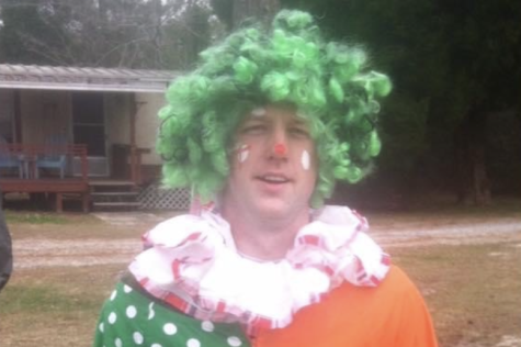 FHN Math Teacher Dan Miner stands dressed up in his clown costume.