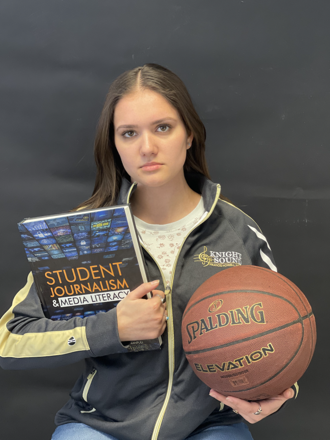 Senior Haylie Bryson hold a textbook and a basketball and wears a Knight Sound jacket. She displays how it feels to have multiple responsibilities as a student.