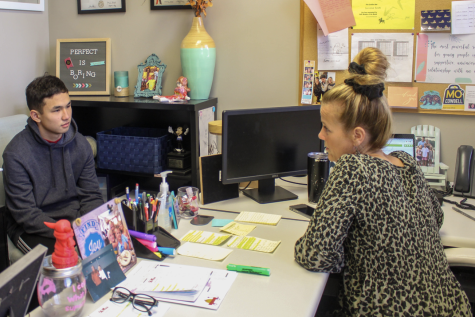 Guidance Counselor Lorraine Smith discusses Summer Classes with a student.