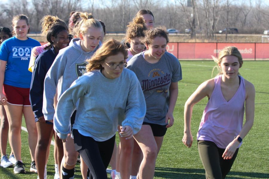 Coaches Rowan Pugh and Barb Hill start off the half-mile jog with the girls lacrosse team at the beginning of the second day of tryouts on Feb. 28. The girls lacrosse coaches Hill and Shelby Pritt are new to the team this year. The team has a full week of tryouts before regular practices begin.