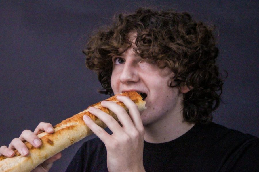 Issac Lopez, a freshman at Francis Howell North, sits in the studio with a baguette. Lopez likes some interesting foods and is pretty open to trying new things. He frequently brings a baguette to school for food and eats it throughout the day.