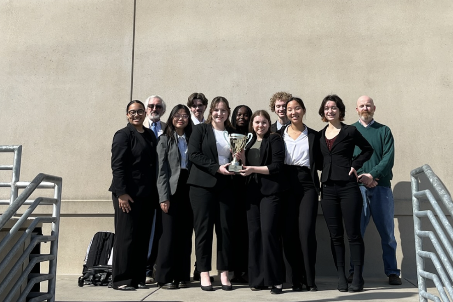 After completing their final trial and winning the State Championship, the FHN Mock Trial team holds the trophy outside of the Eastern Jackson County Courthouse on April 2. 