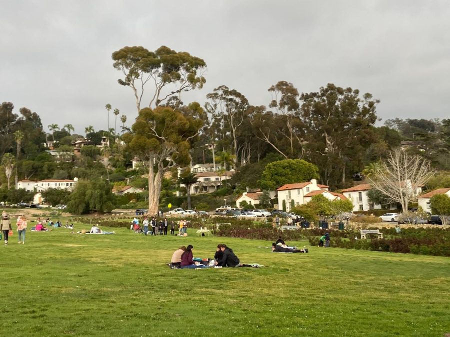 People sit and have a picnic in the park. Many public parks are being destroyed for housing developments. 