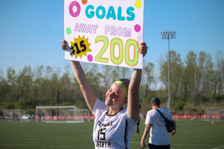Kendra Swope displays her sign showing that she scored a new personal record of 200 goals.