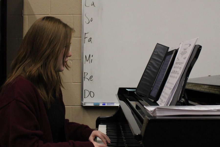 Senior Payten Davis practices her music along with playing on the Piano.