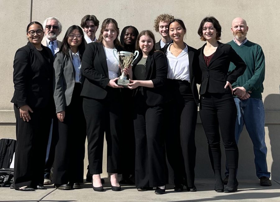 The mock trials members stand after winning state. 