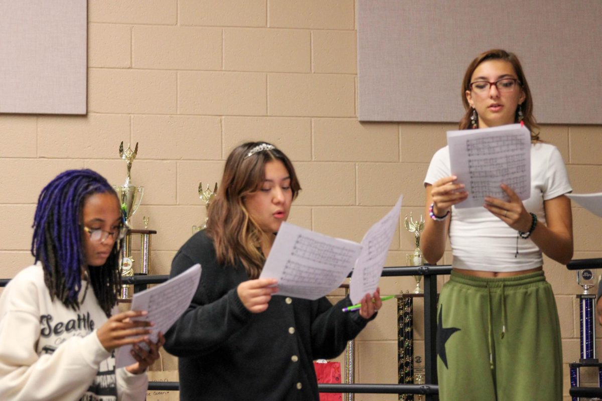 Juniors Akili Griffin, Melissa Guerrero-Bernal and Samantha Felty practice for the upcoming choir concerts.