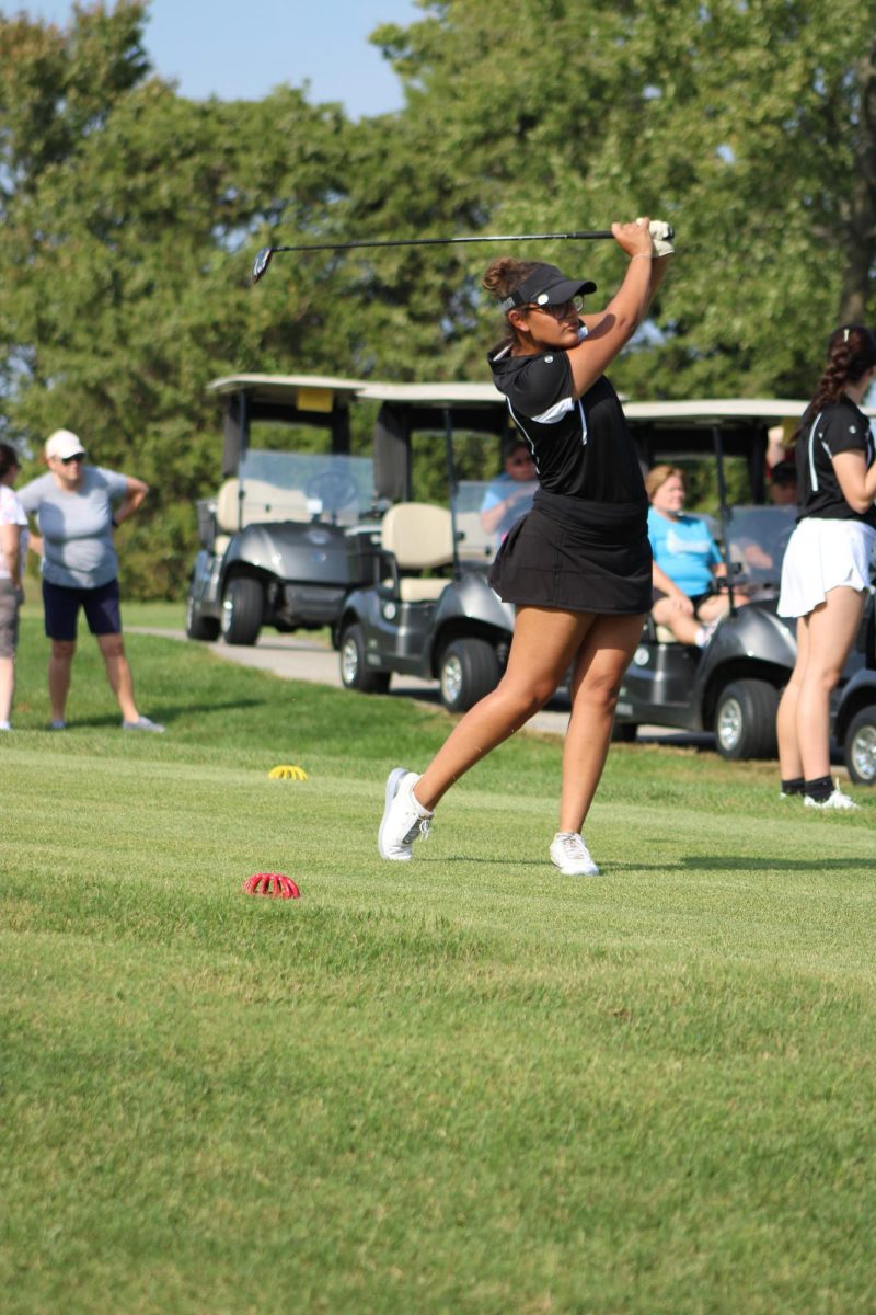 Liza Burgos hits a ball at a golf match. Burgos has been playing golf for 10 years. 