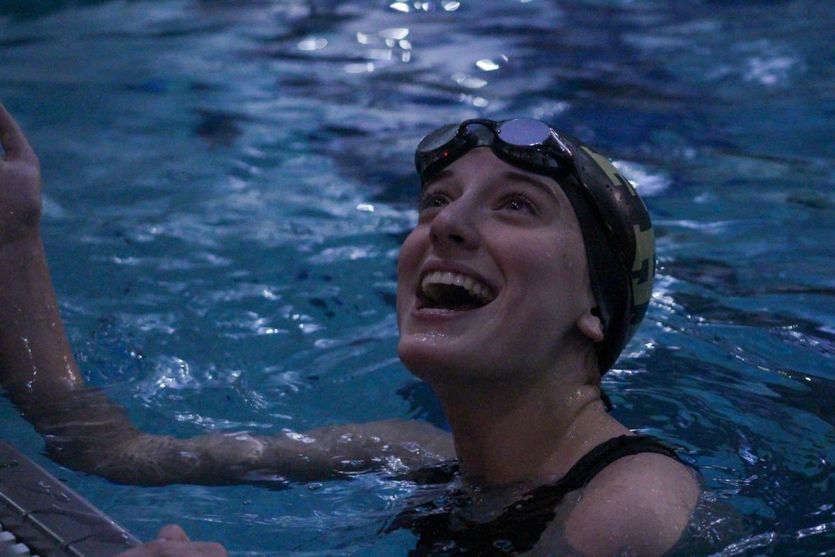 Senior Hannah Button smiles at her teammates after competing in a swim meet against St. Charles West. Button has been a swimmer at FHN for the past two years and is about to start her third year on the team. She is also a lifeguard at the Rec-Plex and swims for fun outside of the school environment.