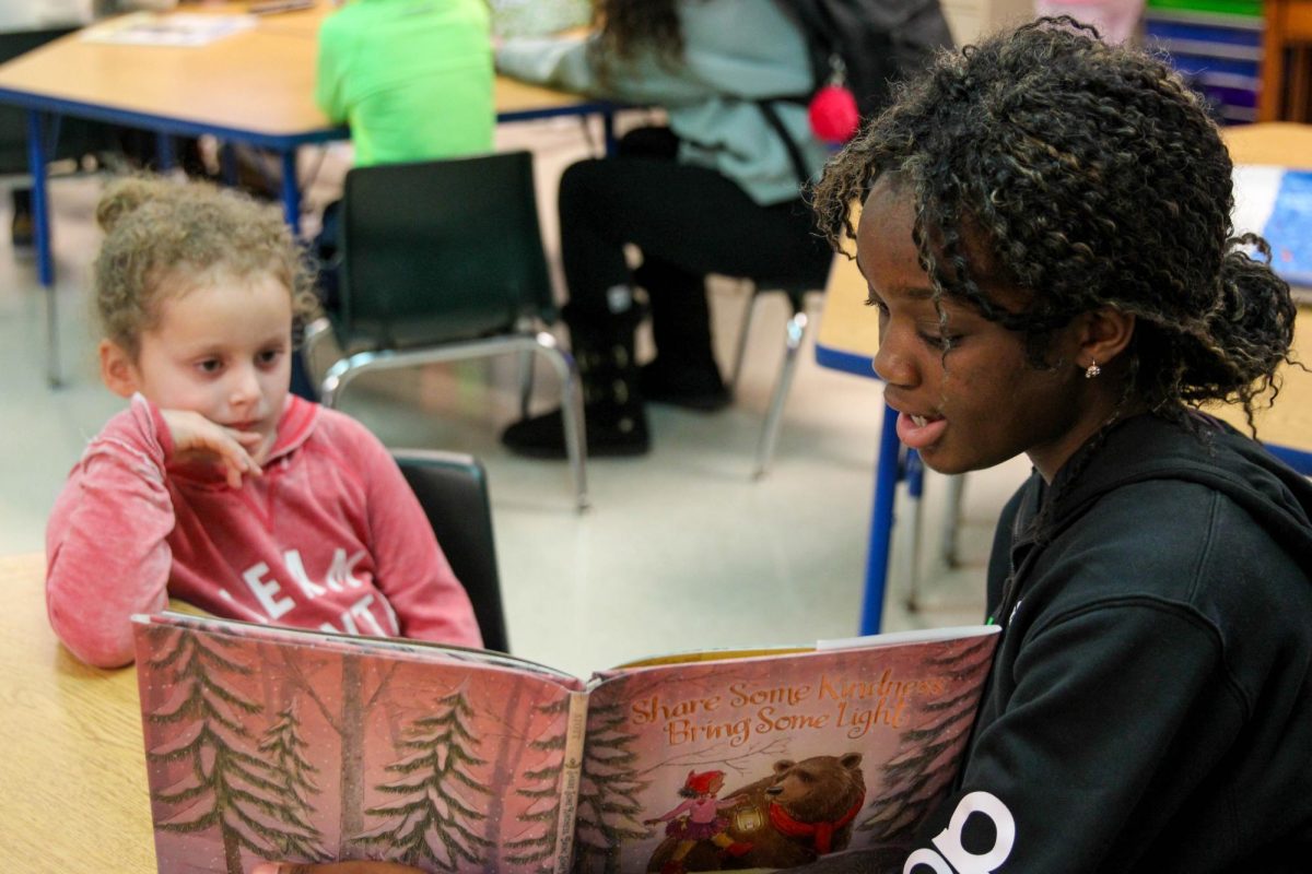 Mac Scholars Read Books with Henderson Elementary Students [Photo Gallery]