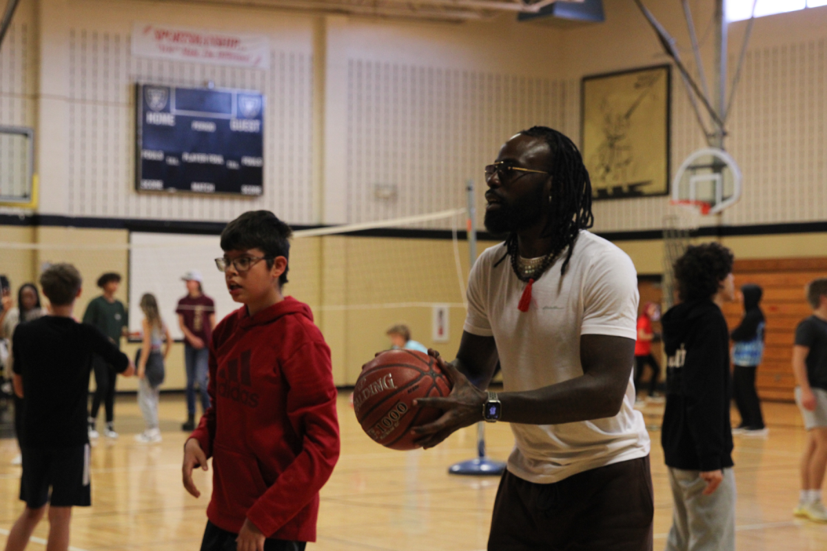 Para professional plays basketball with a student in the FHN gym. Hes a very social and friendly member of our FHN community. As well he built relationships with our FHN basketball knights.
