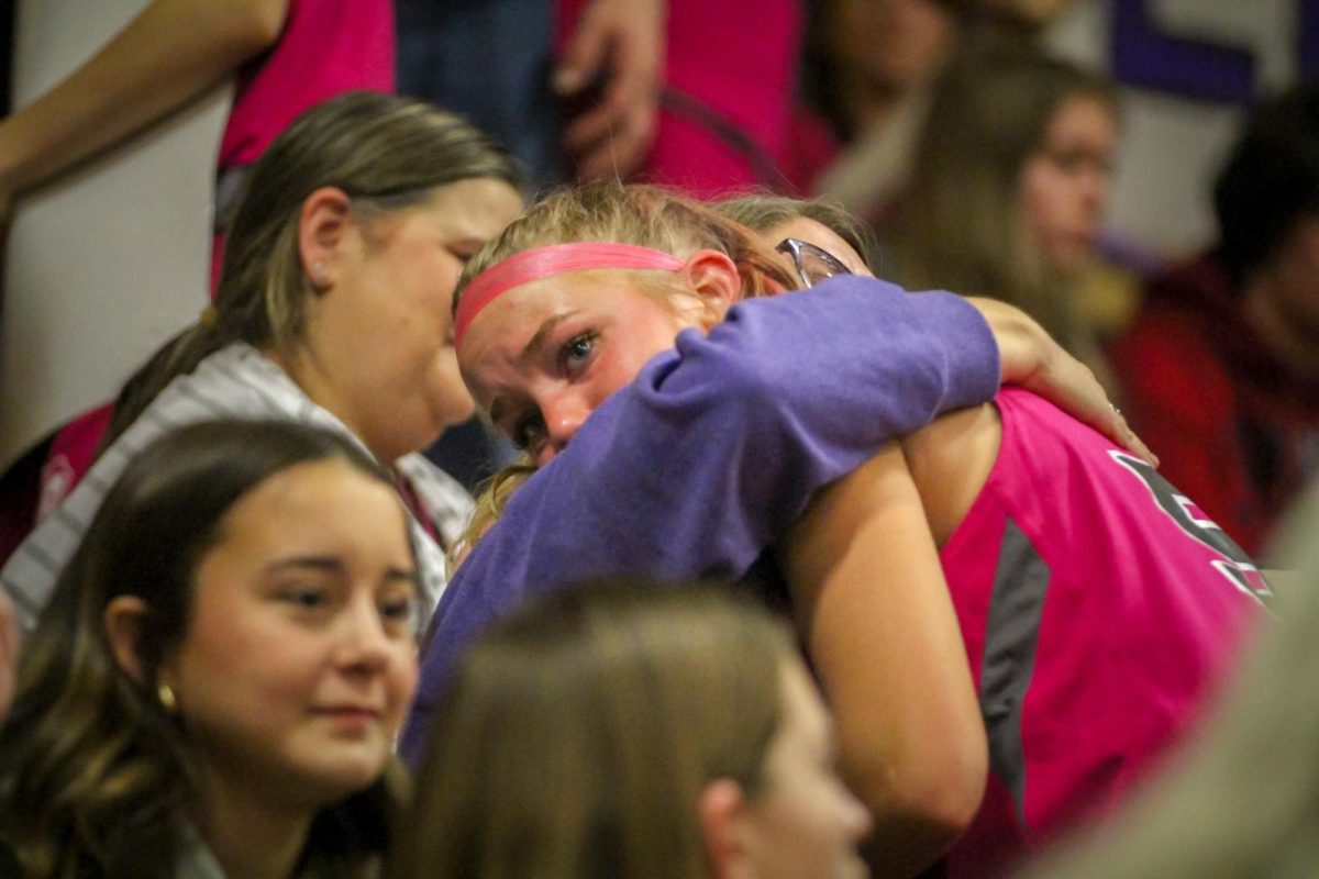 Senior Kendra Swope hugs her mom while in tears during the annual pink out game on Jan. 19.
