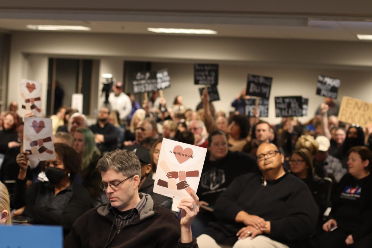 Members of the Francis Howell community hold up signs to show their disapproval with the Board of Educations removal of the Black Lit. and Black History classes at the Jan. 18 board meeting.