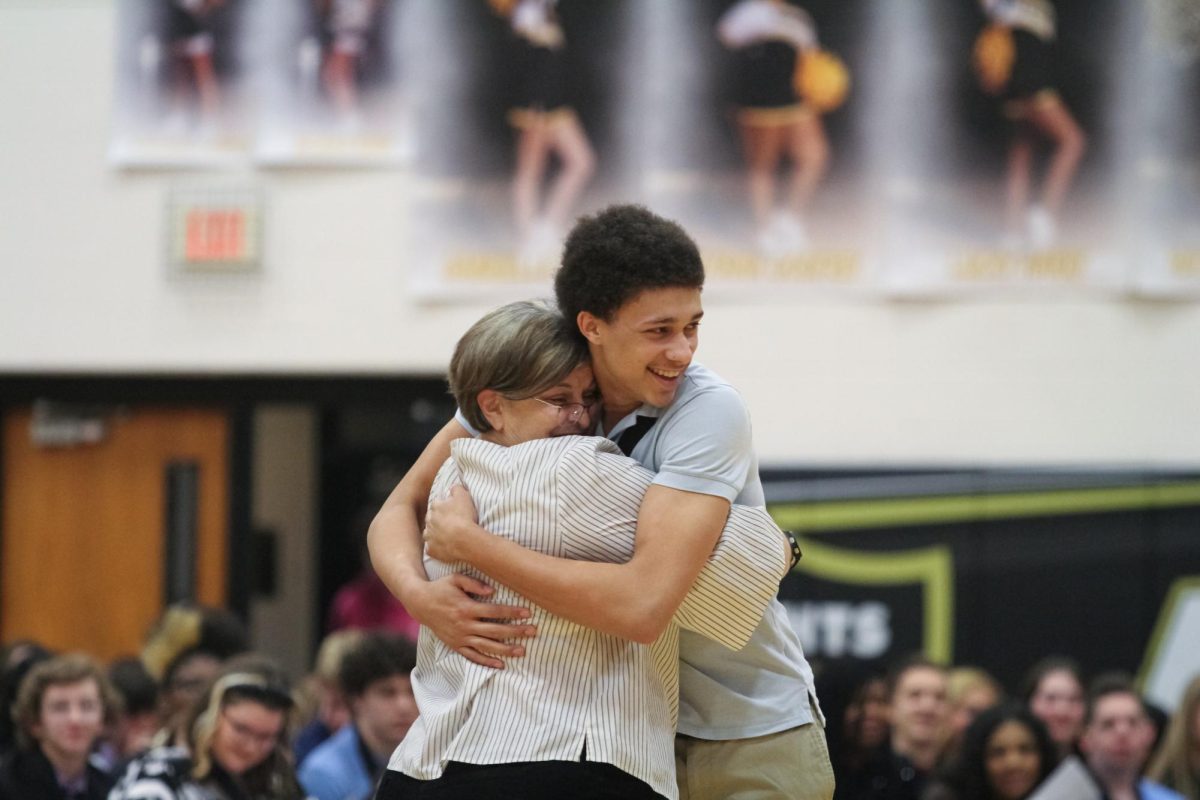 Senior Walter Hammond hugs a FHN staff member who nominated him for the 2024 Knights of the Round Table event. 