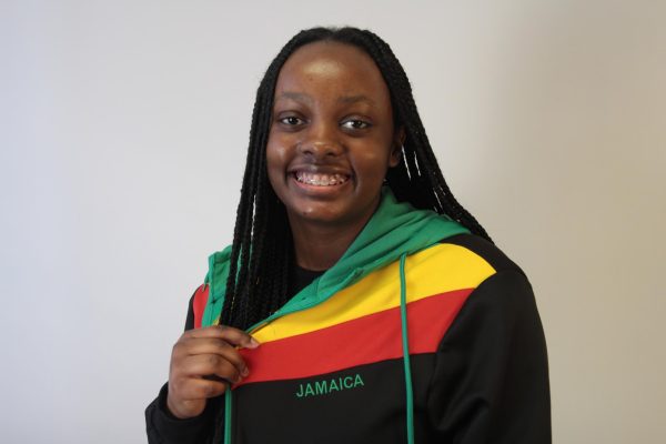 Junior Havana York shows off her Jamaican jacket that features the bold colors of the Jamaican flag. 