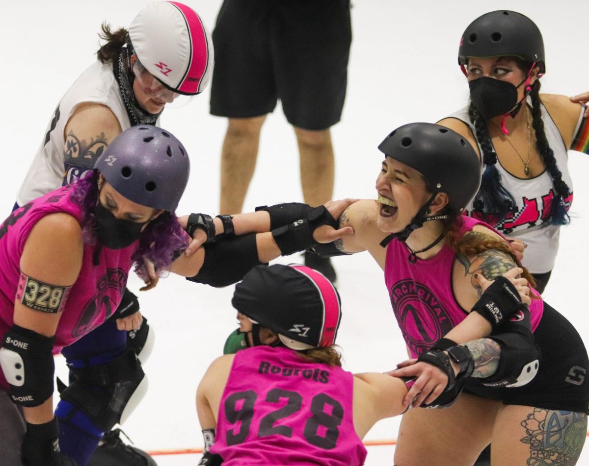 A blocker on the pink team laughs while setting up at the beginning of a jam during a scrimmage on Feb. 17. Every jam, blockers and pivots set up together in circles to stop the jammers from getting through. Roller derby is a collaborative sport that requires all players to rely on and trust each other to get their jammers through and ultimately score points.

I think just being in a space where you are welcomed no matter what is empowering and just knowing that I can come here and play with teammates who are welcoming no matter what is great, second-year player Emma Moscatello said.
