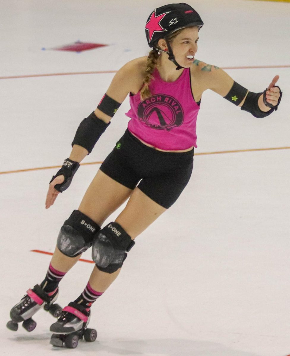 Beth Henry, whose derby name is Jedi, skates around the track during the final scrimmage of the night on Feb. 17. During this jam, Henry was the lead jammer, so she held up her thumb to let the blockers on her team know what to do. Roller derby is a demanding sport, but players find it rewarding nonetheless. 

Attending practice two or three times a week is another time that could be spent relaxing, first year skater Rabia Polzin said. But if its between laying at home or getting in shape and being around people and community, its a great trade off, frankly.
