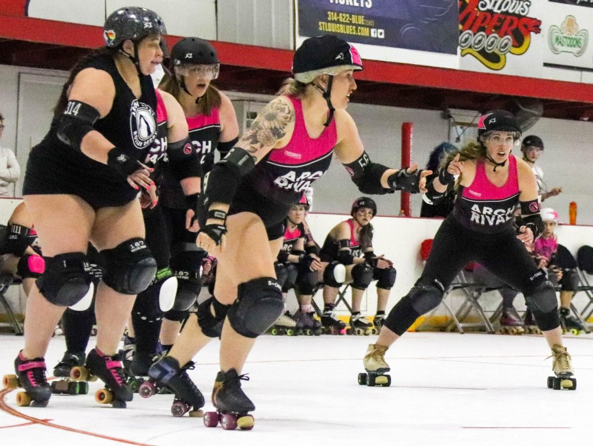 The black teams jammer skates around the track, calling to her teammates to help her get through the other team on Feb. 17 during a scrimmage. The jammers are the only players who can score points during a game. While the player holding the jammer position changes throughout the game, they are always signified by the star cap on their helmet. Jammers get points for their team by skating quickly around the track, past opposing players, gaining one point for every opposing player they pass without touching.

Its a fast-paced, exciting game, derby announcer Steve Dixon said. A lot of times the score is very close, even down to the wire.
