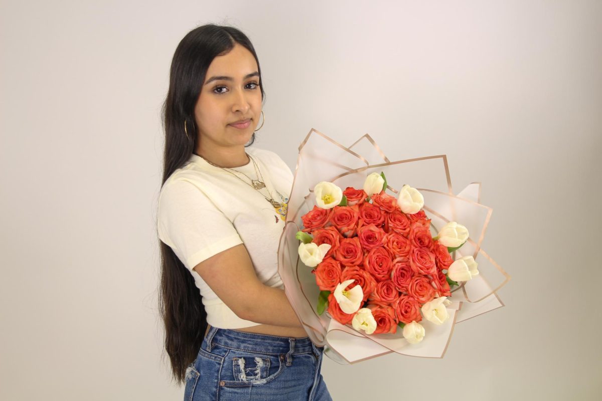 Sophomore Yocelyn Gonzalez poses with a flower bouquet she arranged.