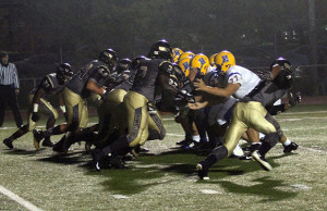 the Knights' offensive line battles with the FHH defensive line