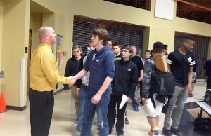Coach Brett Bevill shakes his players hands after their first meeting on Wed, March 2 (Jacob Lintner