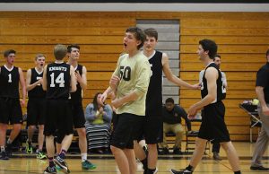 Jake Oppenborn (center) and the boys volleyball team celebrate after a point scored (Kristen Pike)