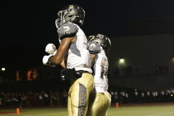 Teammates Maurice Massey and Ronald Woods celebrate after a Knights first down (Chase Meyer)